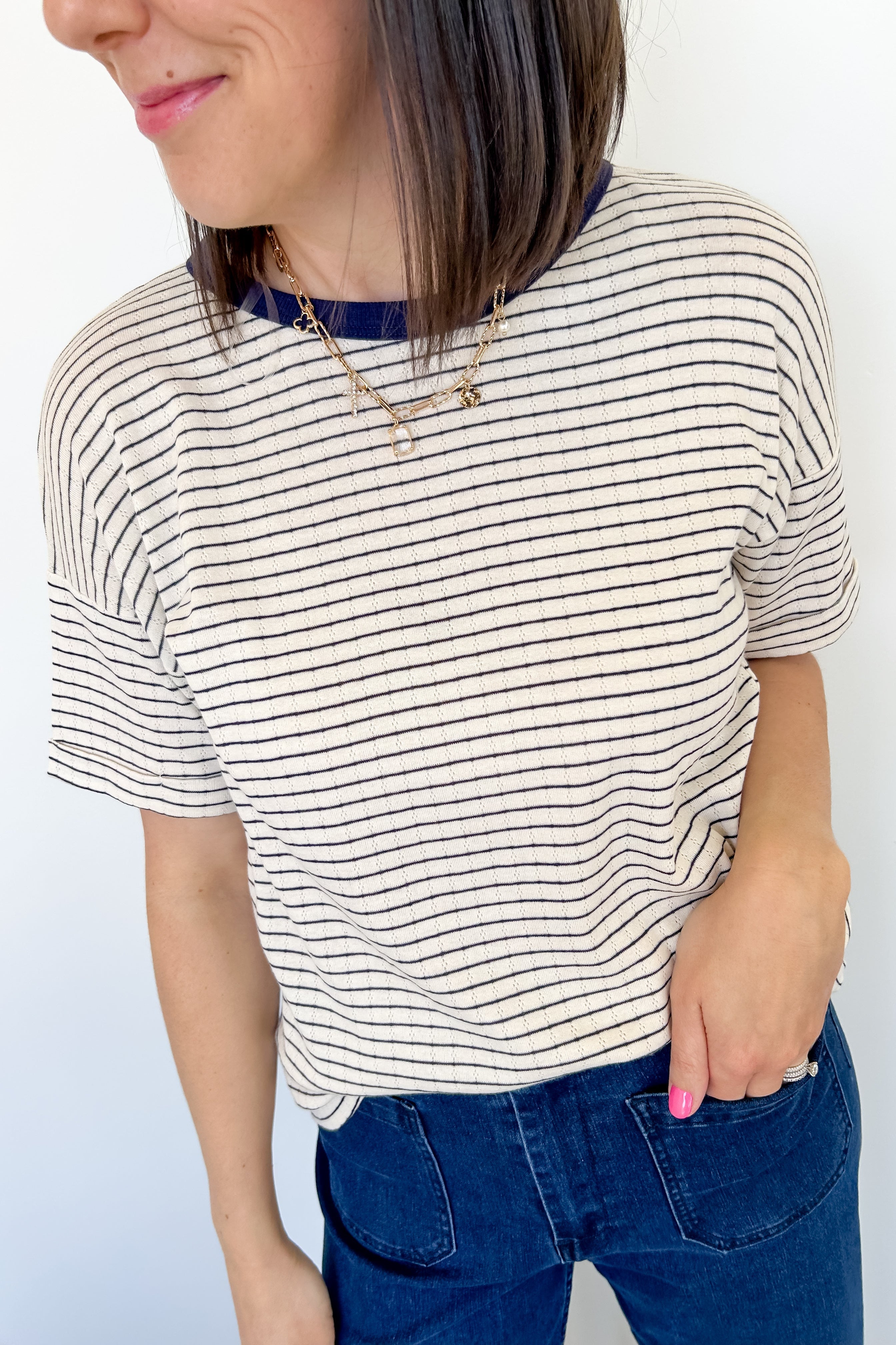 Photo of model wearing a pointelle striped tee with navy stripes 
