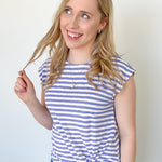 Photo of model wearing a striped top with twisted hem and cap sleeves