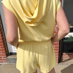 Hooded romper with stretchy waistband. Zipper front. Pockets. Short sleeve.