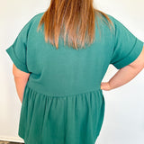 Person wearing a green blouse with a plain white background