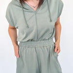 Hooded romper with stretchy waistband. Zipper front. Pockets. Short sleeve.
