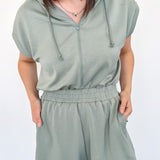 Hooded romper with stretchy waistband. Zipper front. Pockets. Short sleeve.
