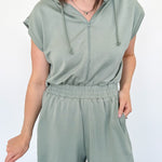 Hooded romper with stretchy waistband. Zipper front. Pockets. Short sleeve.