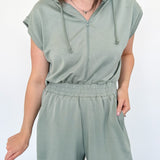 Hooded romper with stretchy waistband. Zipper front. Pockets. Short sleeve.
