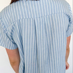 Light blue collared button up top with white stripe details. Short sleeve. 
