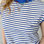 Blue and white striped top with necklaces.