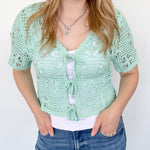Mint crochet cropped sweater with three ties in the front. Perfect for layering over a tank or dress.