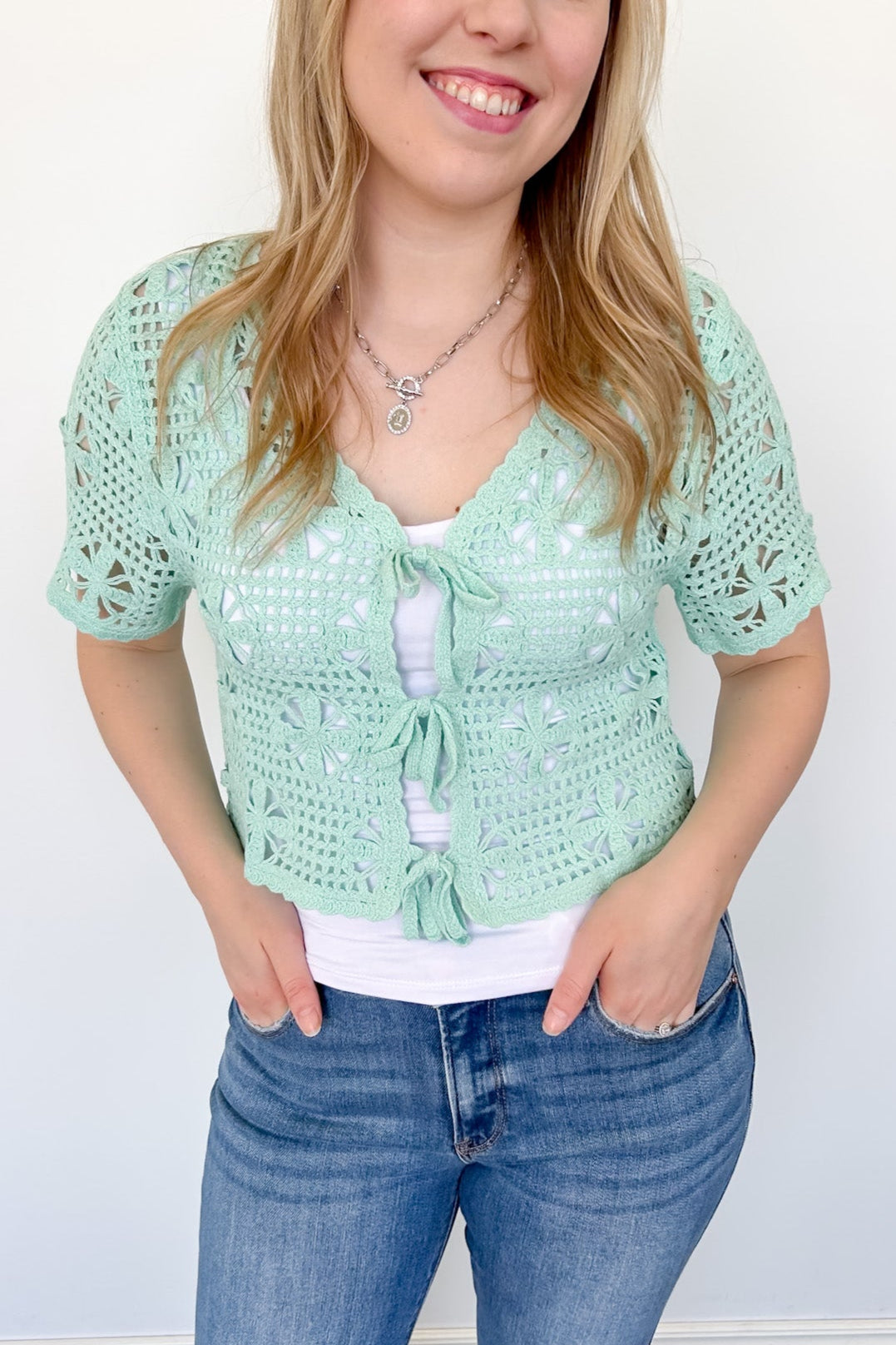 Mint crochet cropped sweater with three ties in the front. Perfect for layering over a tank or dress.