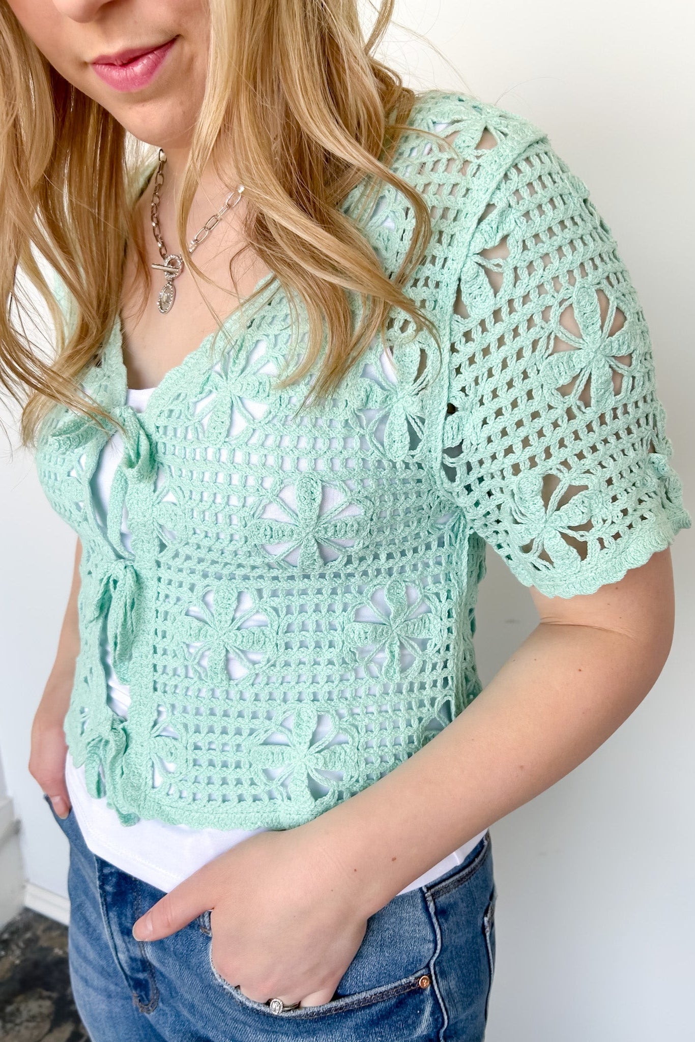 Mint crochet cropped sweater with three ties in the front. Perfect for layering over a tank or dress.