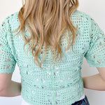 Mint crochet cropped sweater with three ties in the front. Perfect for layering over a tank or dress.
