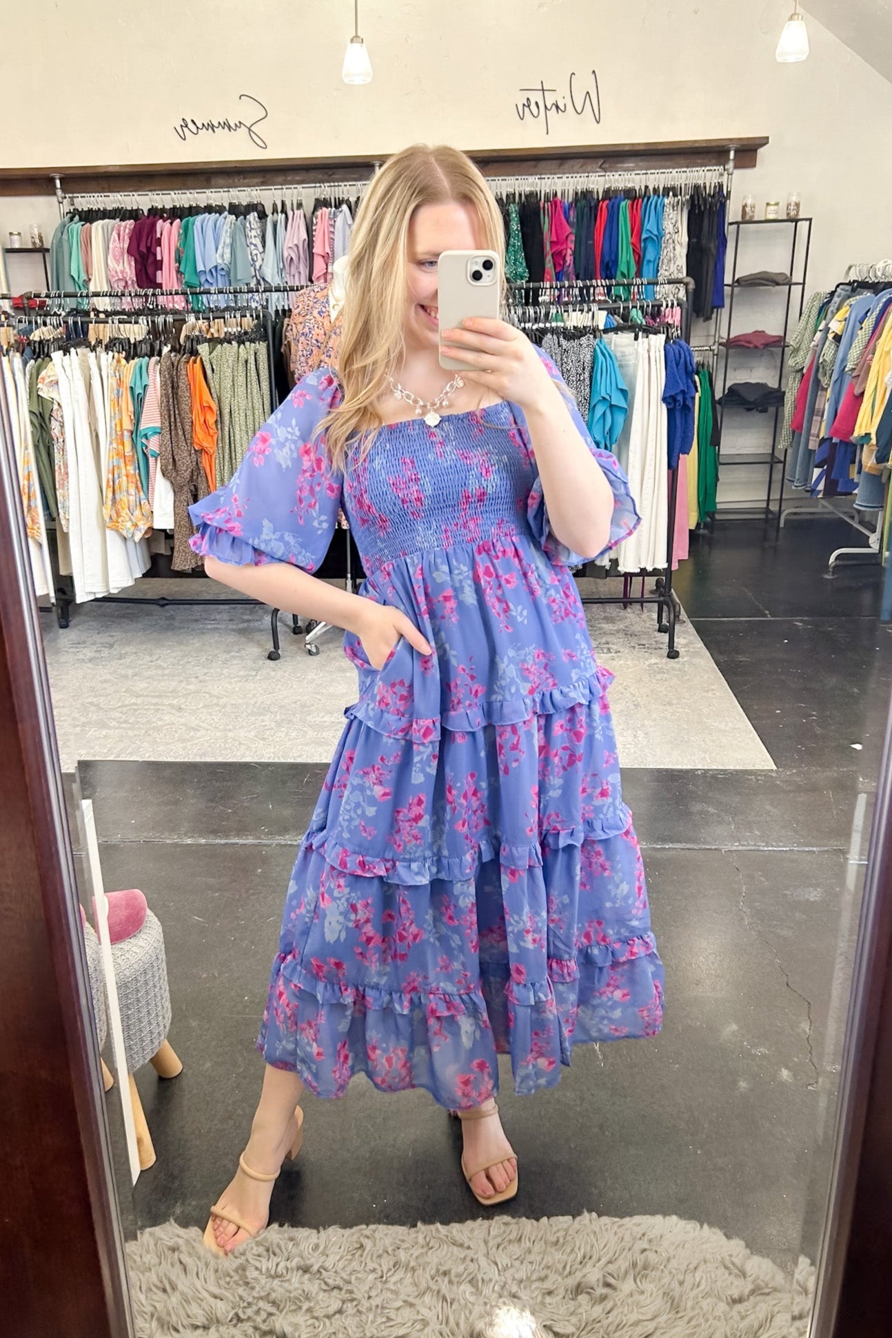Flowy floral print dress with colors periwinkle and hot pink. Smocked bodice. Puff sleeves with tiered bottom. 