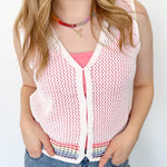 White sweater tank top with rainbow colors around the bottom. Button up. Layered with tank top underneath.