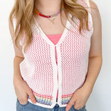 White sweater tank top with rainbow colors around the bottom. Button up. Layered with tank top underneath.