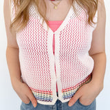 White sweater tank top with rainbow colors around the bottom. Button up. Layered with tank top underneath.