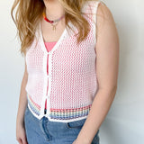White sweater tank top with rainbow colors around the bottom. Button up. Layered with tank top underneath.