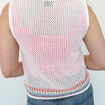 White sweater tank top with rainbow colors around the bottom. Button up. Layered with tank top underneath.