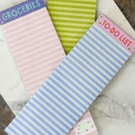 Four small notepads with different designs and text on a marble surface.