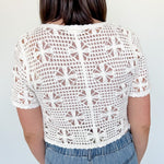 White crochet cropped sweater with three ties in the front. Perfect for layering over a tank or dress.