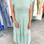 Smocked top dress with short sleeves. Ruffle sleeves. Midi length with tiers. 