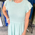Smocked top dress with short sleeves. Ruffle sleeves. Midi length with tiers. 