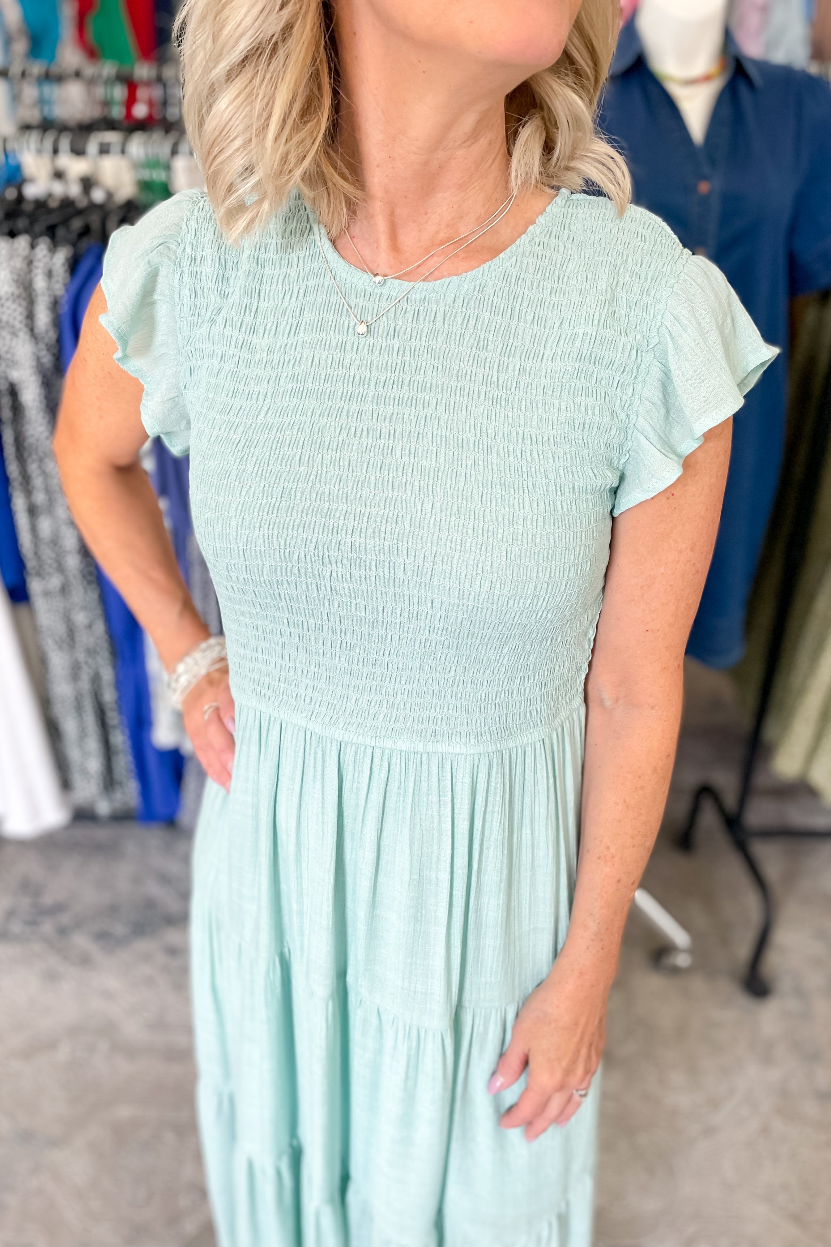 Smocked top dress with short sleeves. Ruffle sleeves. Midi length with tiers. 