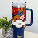 Floral-patterned tumbler with handle on a white surface, featuring 'the Darling Effect' branding.