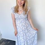 Floral print midi length dress. Blue and white in color. V neckline with flowy bottom and ruffles short sleeves.