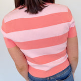 Pink and coral toned striped sweater. High neckline. Slightly cropped fit. Short sleeve style.