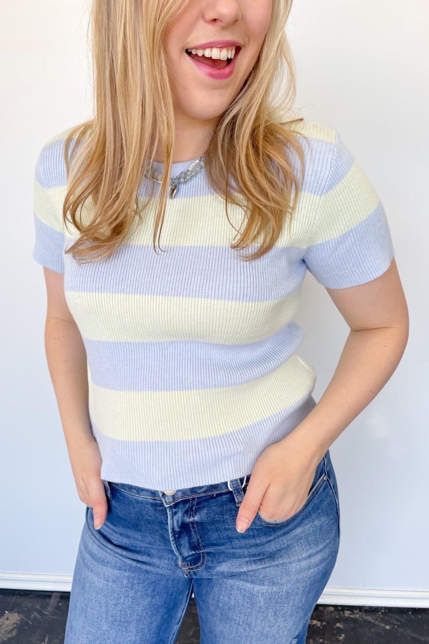 Blue and cream striped sweater top. High neckline. Slightly cropped style.