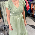 Olive green midi length dress with embroidered flower detail. Smocked top. Short sleeves.