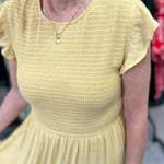 Smocked top dress with short sleeves. Ruffle sleeves. Midi length with tiers. 