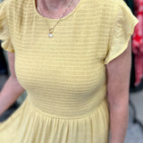 Smocked top dress with short sleeves. Ruffle sleeves. Midi length with tiers. 