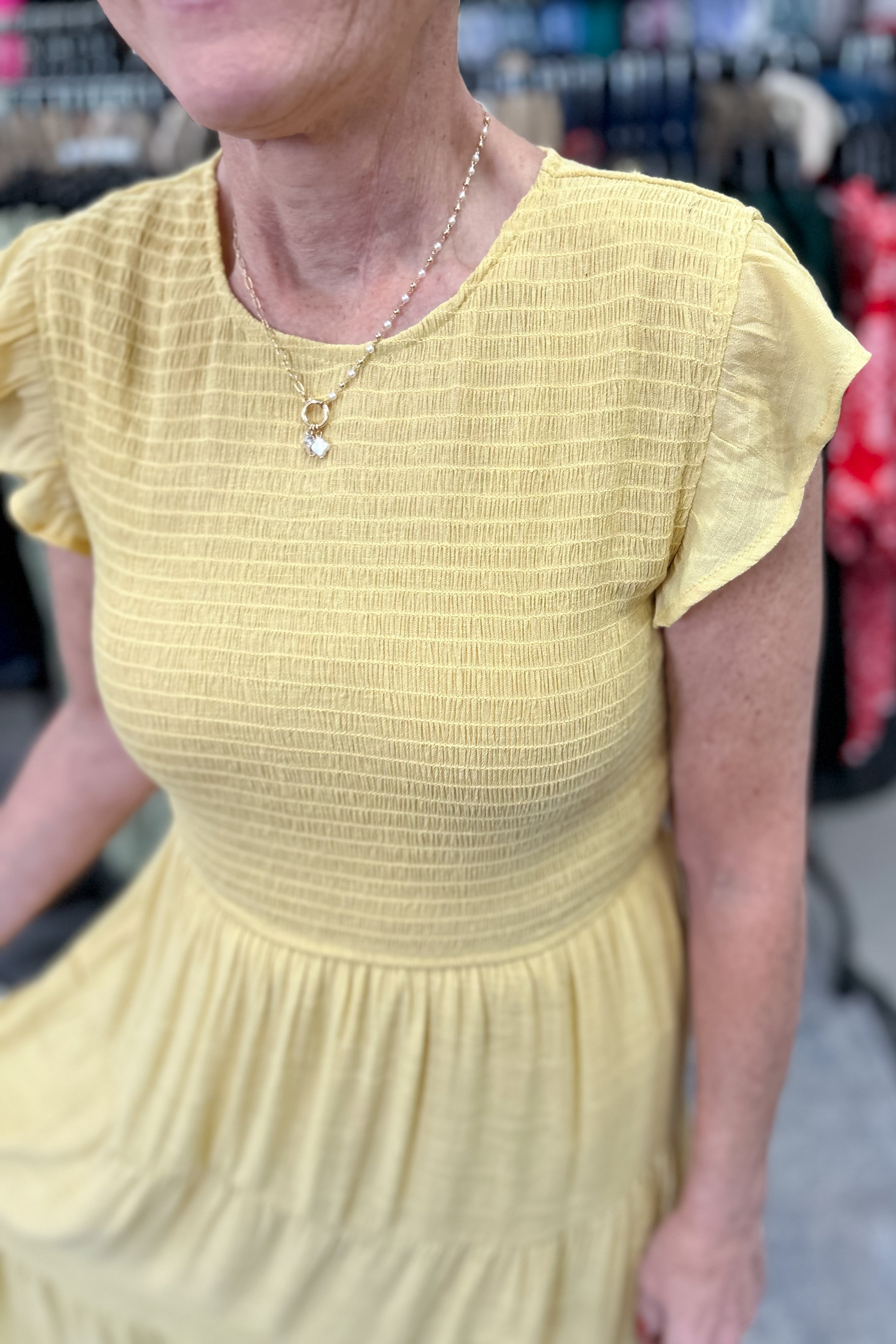 Smocked top dress with short sleeves. Ruffle sleeves. Midi length with tiers. 