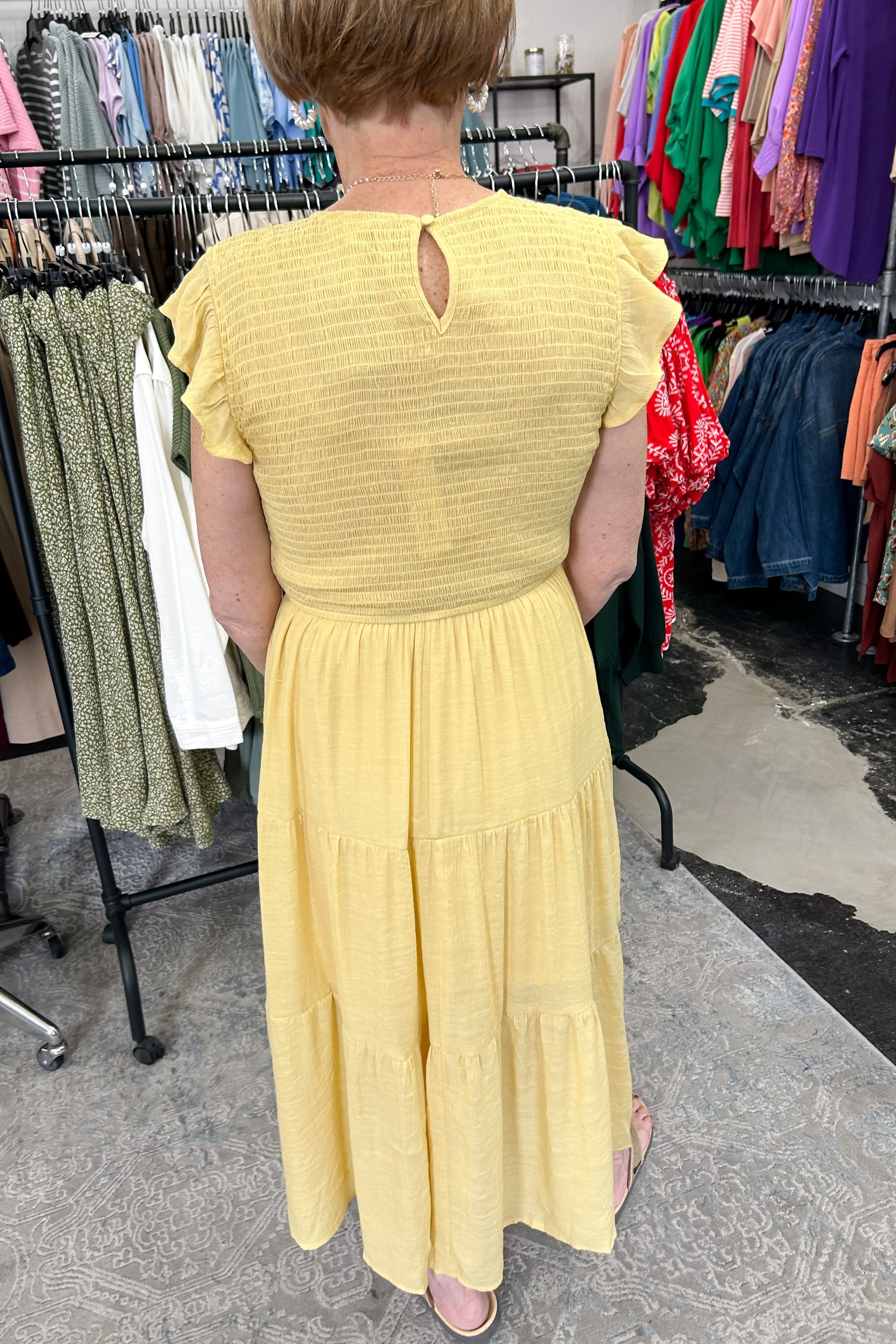 Smocked top dress with short sleeves. Ruffle sleeves. Midi length with tiers. 