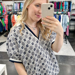Patterned top. V neckline. Short sleeve. Regular fit. Navy and white in color.