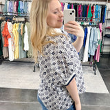 Patterned top. V neckline. Short sleeve. Regular fit. Navy and white in color.