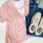 Babydoll style stop with open button up front. Short sleeve. Lightweight sweater material. Light pink in color.