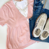 Babydoll style stop with open button up front. Short sleeve. Lightweight sweater material. Light pink in color.