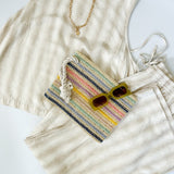 Striped tank and matching pants set. High neckline on top and regular fitting pants. Elastic waistline with tie.  White and tan in color.