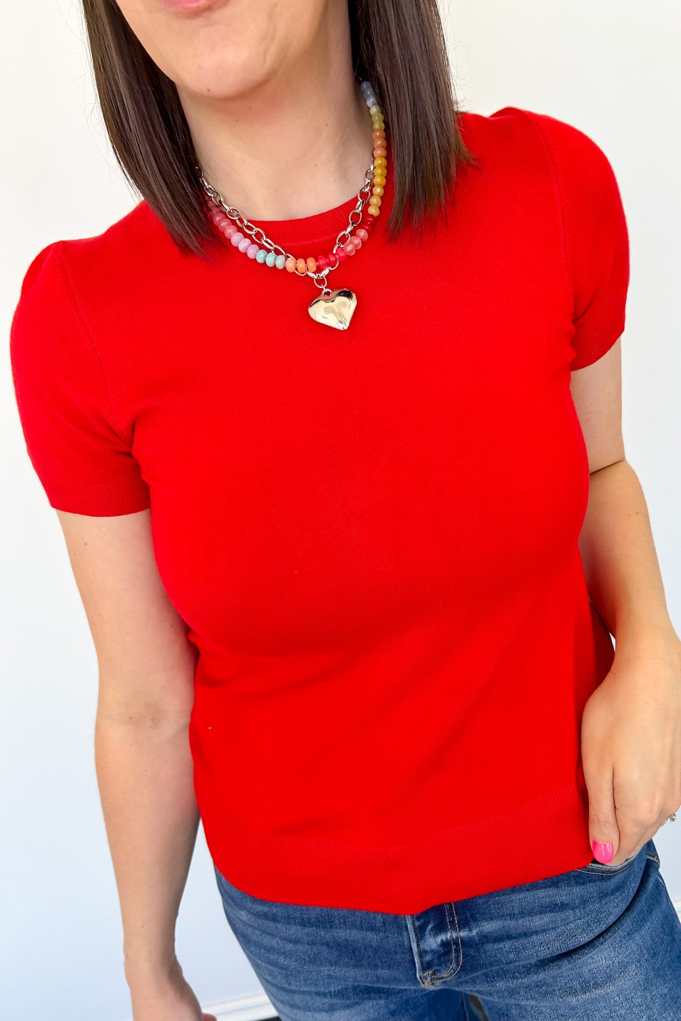 Red short sleeve top with round neckline. Fitted style. Regular length. 