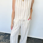 Striped tank and matching pants set. High neckline on top and regular fitting pants. Elastic waistline with tie.  White and tan in color.