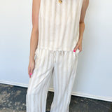 Striped tank and matching pants set. High neckline on top and regular fitting pants. Elastic waistline with tie.  White and tan in color.