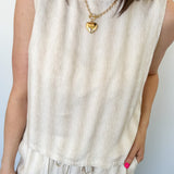 Striped tank and matching pants set. High neckline on top and regular fitting pants. Elastic waistline with tie.  White and tan in color.