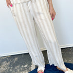 Striped tank and matching pants set. High neckline on top and regular fitting pants. Elastic waistline with tie.  White and tan in color.