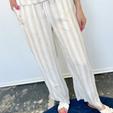 Striped tank and matching pants set. High neckline on top and regular fitting pants. Elastic waistline with tie.  White and tan in color.