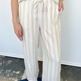 Striped tank and matching pants set. High neckline on top and regular fitting pants. Elastic waistline with tie.  White and tan in color.