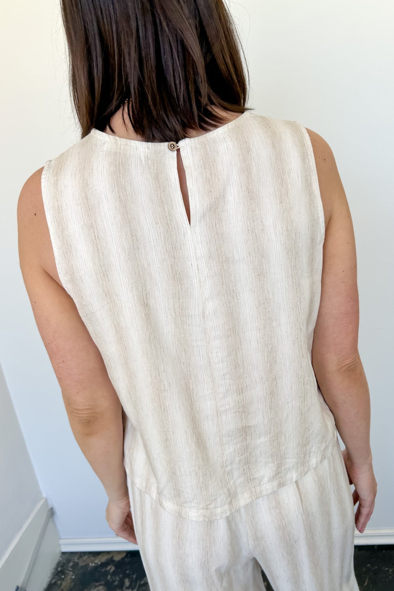 Striped tank and matching pants set. High neckline on top and regular fitting pants. Elastic waistline with tie.  White and tan in color.