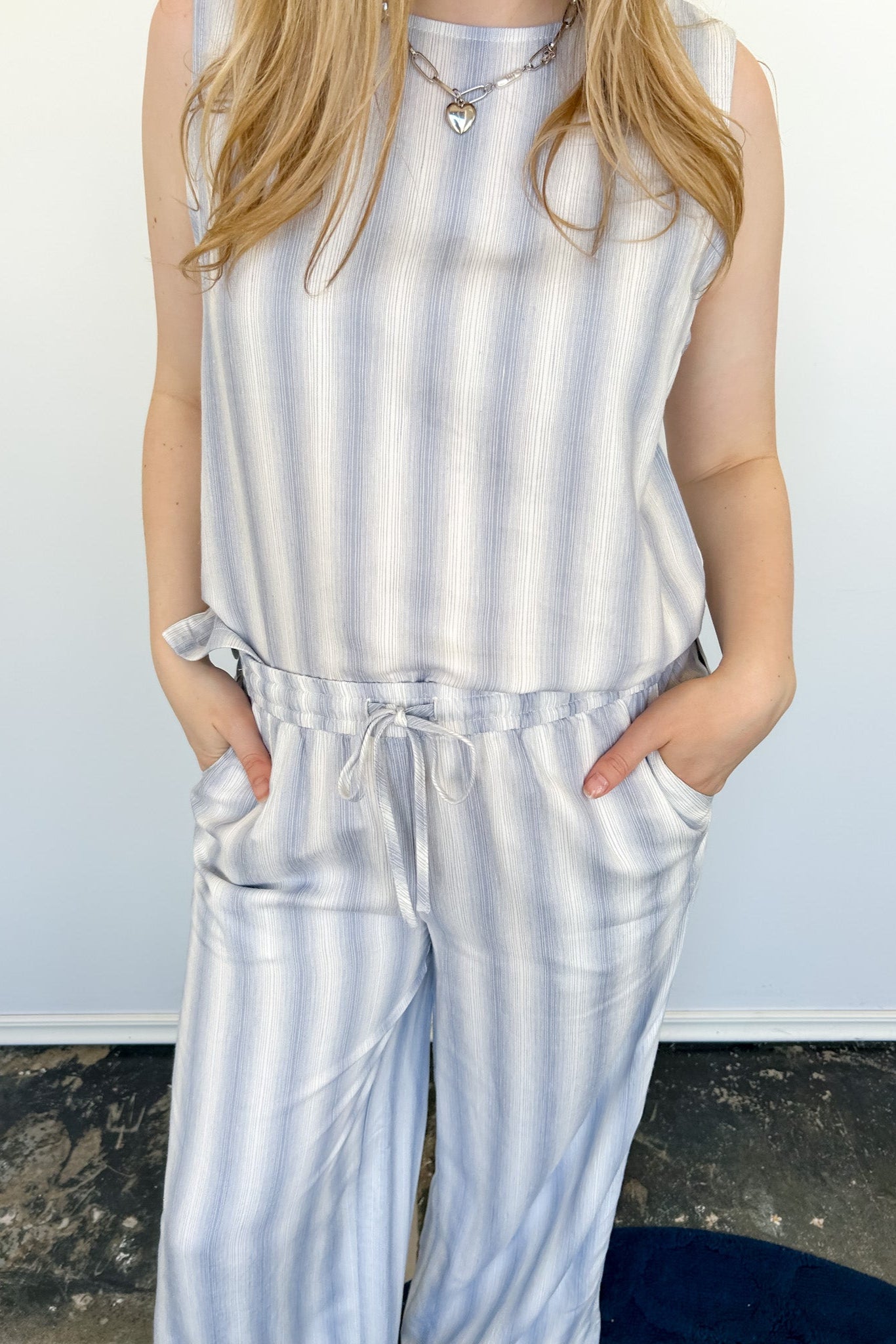 Striped tank and matching pants set. High neckline on top and regular fitting pants. Elastic waistline with tie.  White and blue in color.