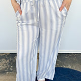 Striped tank and matching pants set. High neckline on top and regular fitting pants. Elastic waistline with tie.  White and tan in color.