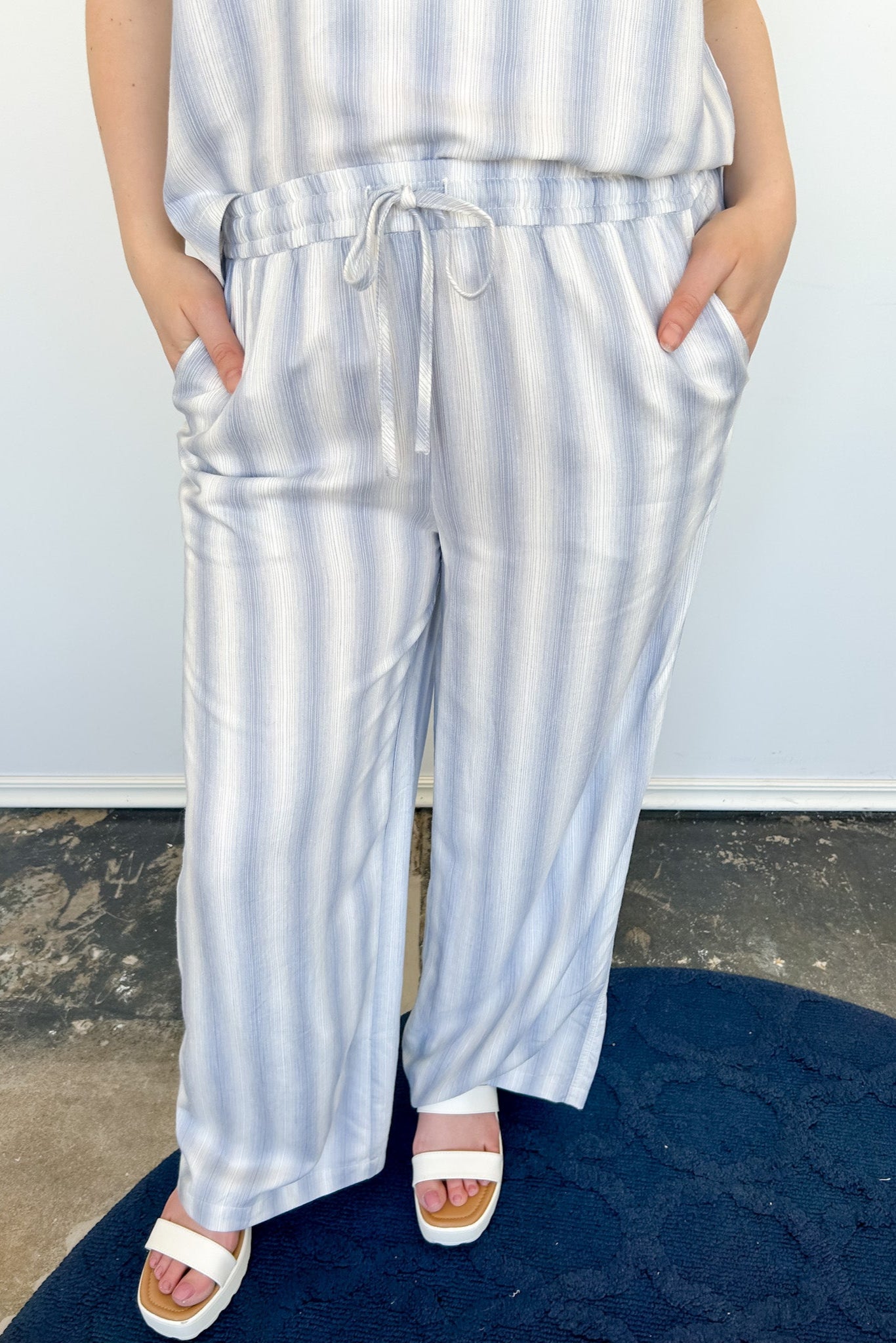 Striped tank and matching pants set. High neckline on top and regular fitting pants. Elastic waistline with tie.  White and tan in color.